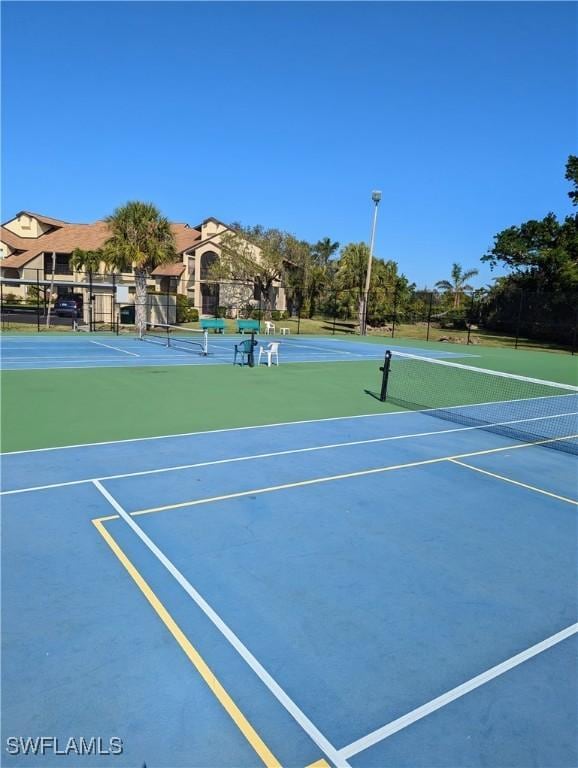 view of sport court featuring fence