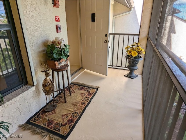 view of exterior entry with stucco siding