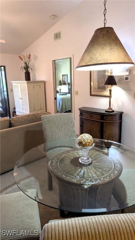 dining room featuring visible vents and vaulted ceiling