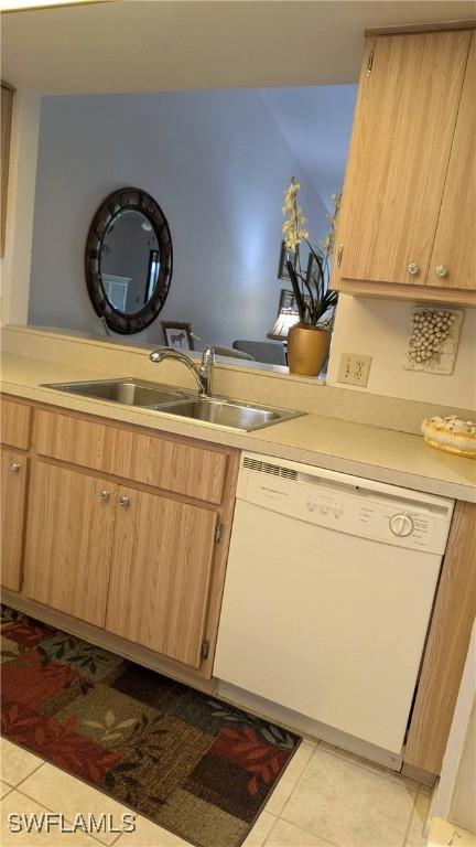 kitchen with light countertops, dishwasher, a sink, and light tile patterned flooring