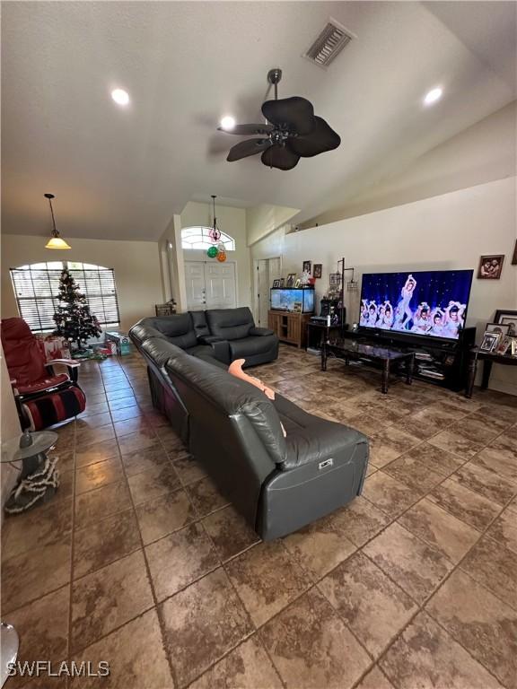 living room with ceiling fan and lofted ceiling