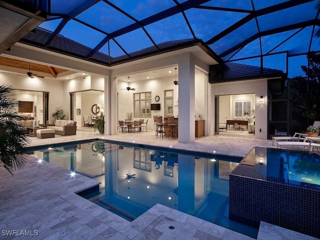 view of pool featuring ceiling fan, a lanai, an outdoor bar, an outdoor hangout area, and a patio