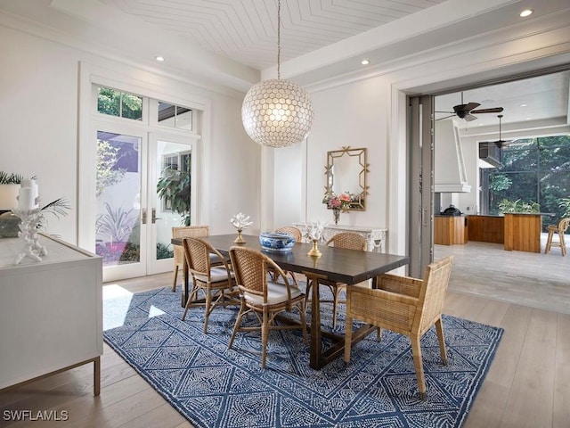 dining space with french doors, light hardwood / wood-style flooring, and ceiling fan