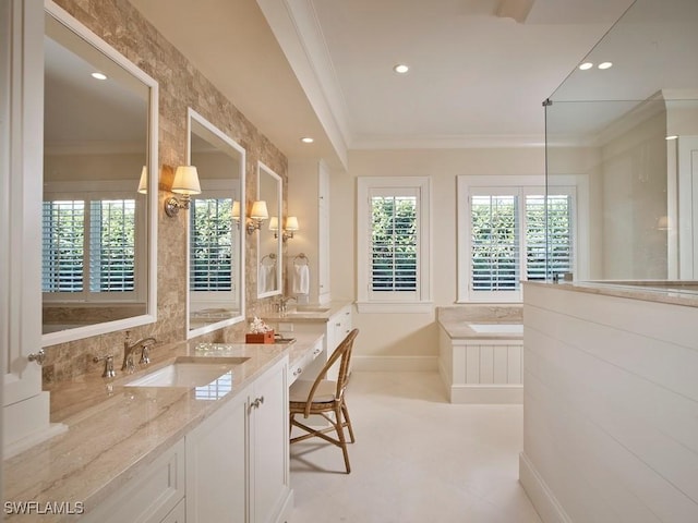 bathroom featuring vanity, a tub to relax in, and crown molding