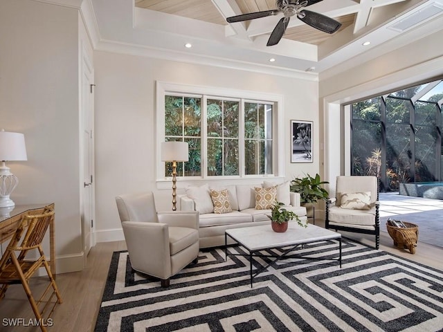 living room with ceiling fan, a healthy amount of sunlight, and coffered ceiling