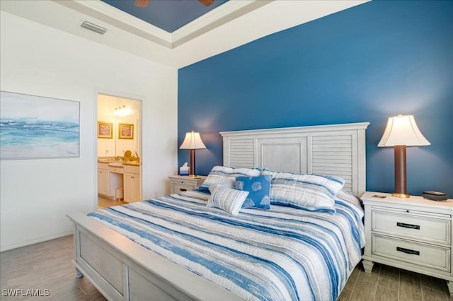 bedroom featuring ensuite bathroom, ceiling fan, and light hardwood / wood-style floors