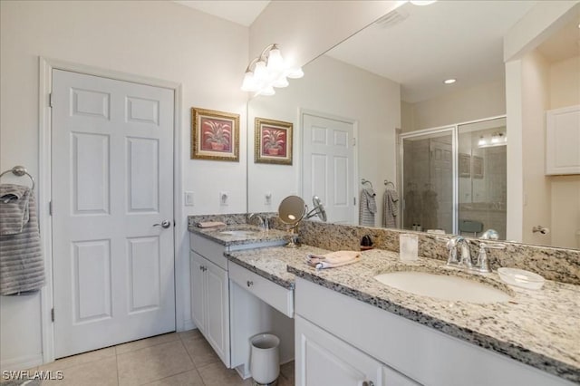 bathroom with tile patterned floors, vanity, and an enclosed shower