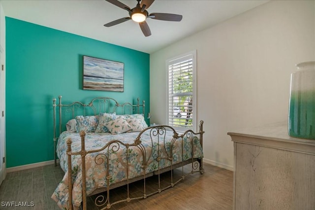 bedroom with ceiling fan and wood-type flooring