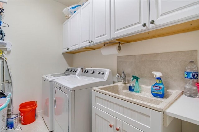 laundry area featuring washer and dryer and cabinets