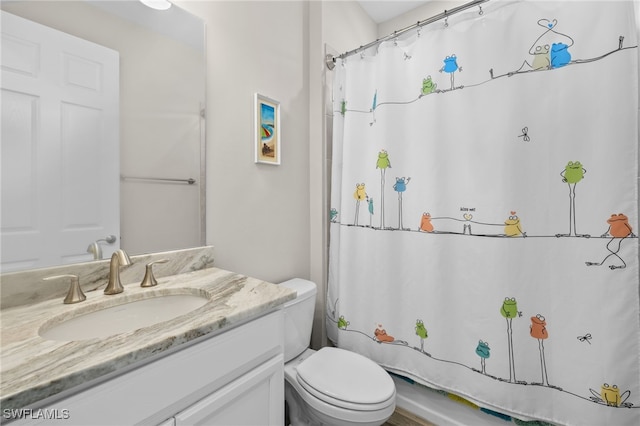 bathroom featuring walk in shower, vanity, and toilet