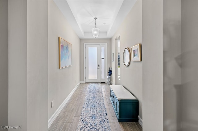 entryway featuring a tray ceiling