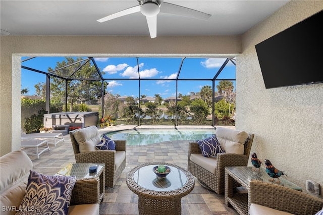 view of patio / terrace featuring glass enclosure, ceiling fan, a hot tub, and an outdoor hangout area