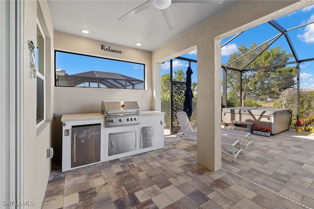 view of patio featuring a grill, ceiling fan, a lanai, area for grilling, and a hot tub