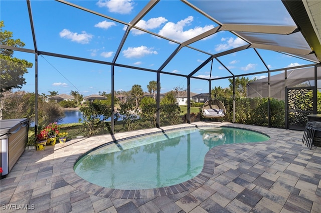 view of swimming pool with glass enclosure, a water view, and a patio