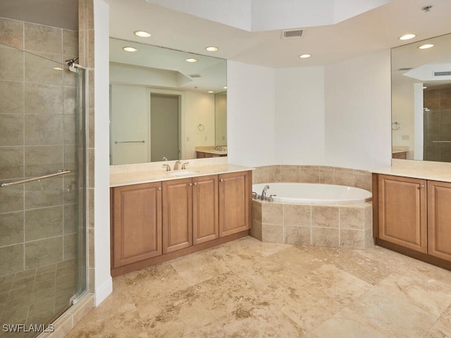 bathroom featuring vanity and separate shower and tub