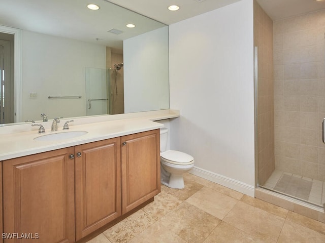 bathroom featuring walk in shower, vanity, and toilet