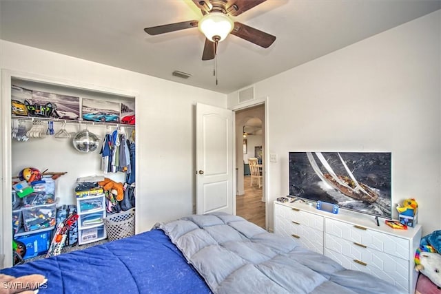 bedroom with wood-type flooring, a closet, and ceiling fan