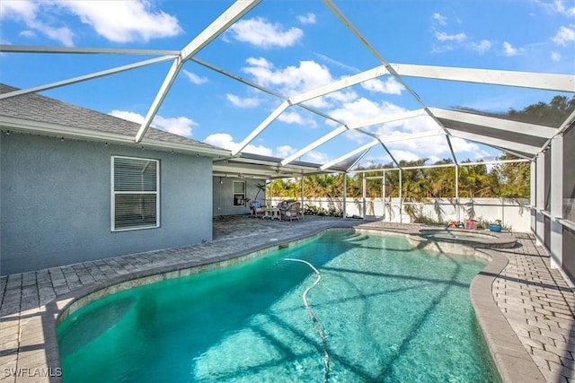 view of swimming pool featuring a lanai, an in ground hot tub, and a patio