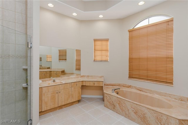 bathroom with tile patterned flooring, shower with separate bathtub, and vanity