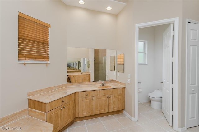 bathroom featuring tile patterned flooring, vanity, toilet, and an enclosed shower