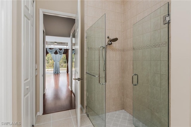 bathroom featuring hardwood / wood-style flooring and an enclosed shower