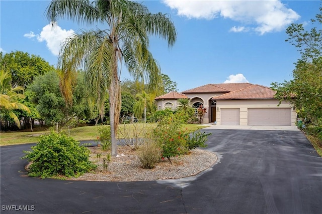 mediterranean / spanish house featuring a garage