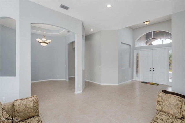 tiled entryway with an inviting chandelier