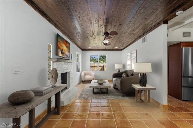 living area with a fireplace, tile patterned flooring, ceiling fan, and wooden ceiling