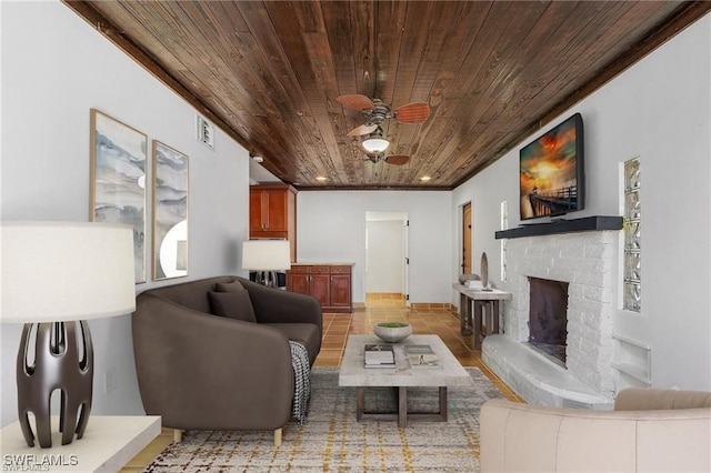 tiled living room with ceiling fan and wood ceiling