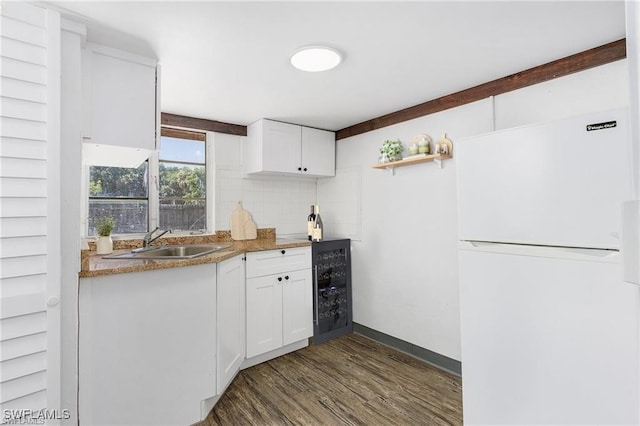 kitchen featuring beverage cooler, sink, white refrigerator, dark hardwood / wood-style floors, and white cabinetry