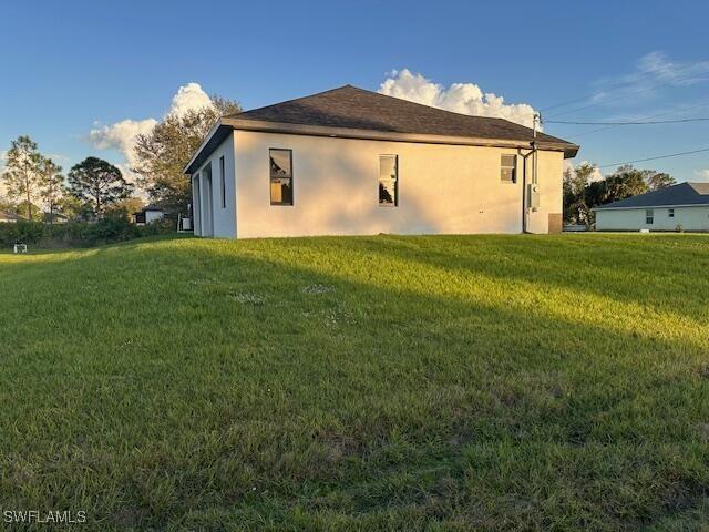 view of property exterior with a lawn