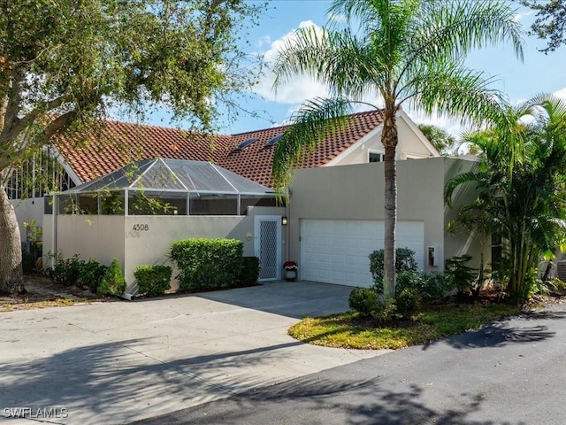 view of front of house featuring a lanai and a garage