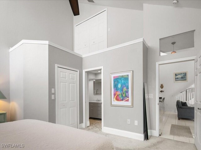 bedroom featuring light carpet, sink, high vaulted ceiling, and ceiling fan