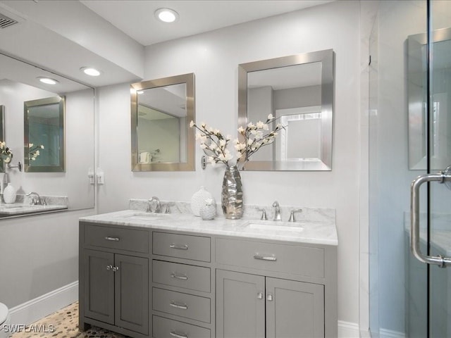 bathroom with vanity and a shower with shower door