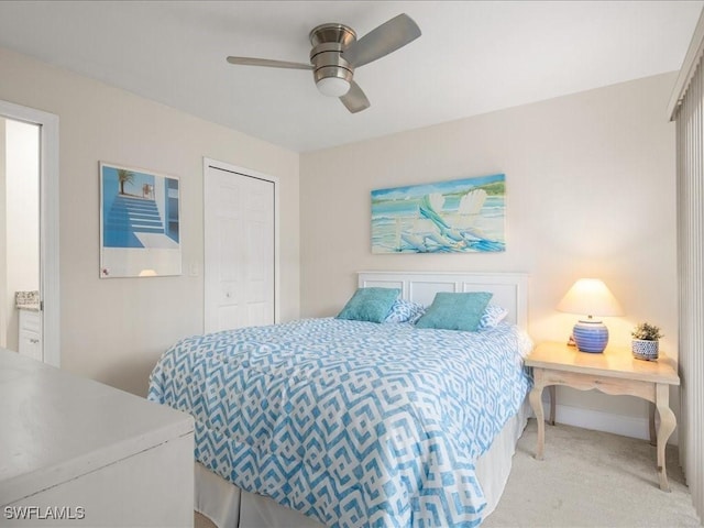 bedroom with ceiling fan, a closet, and light carpet