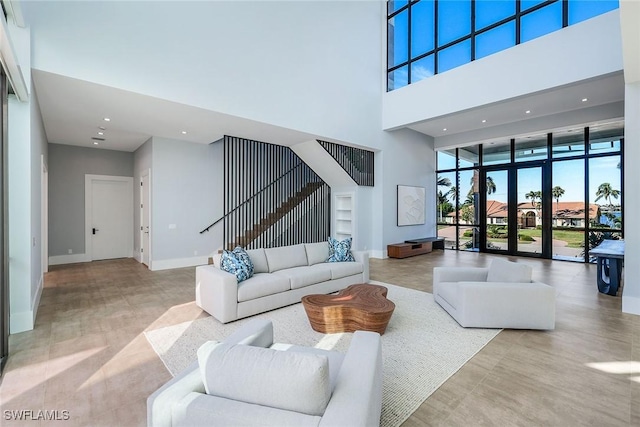 living room with a high ceiling and french doors