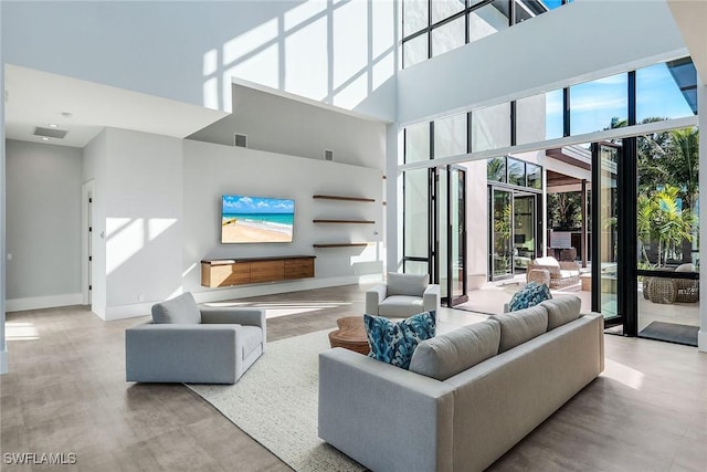 living room featuring a towering ceiling