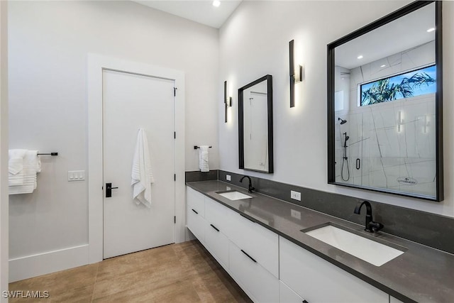 bathroom with a shower with door and vanity