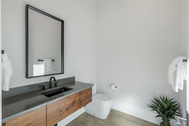 bathroom with tile patterned floors, vanity, and toilet