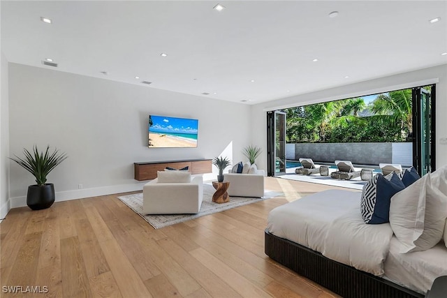 bedroom featuring access to outside and light hardwood / wood-style flooring