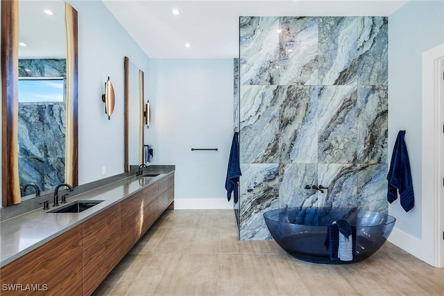 bathroom featuring vanity, tile walls, and a bathing tub