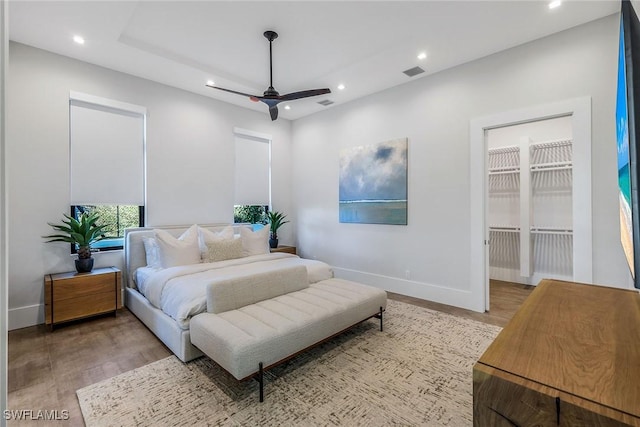 bedroom featuring access to outside, light hardwood / wood-style flooring, and ceiling fan