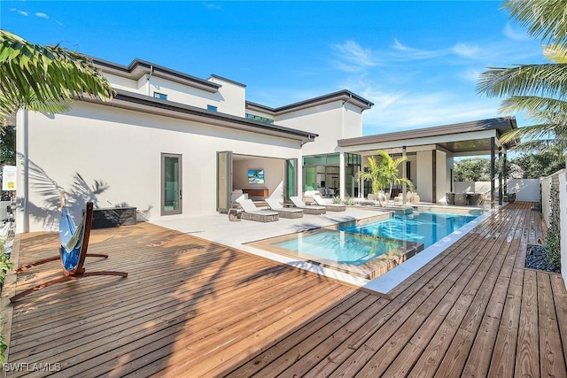 view of swimming pool with a deck and an in ground hot tub