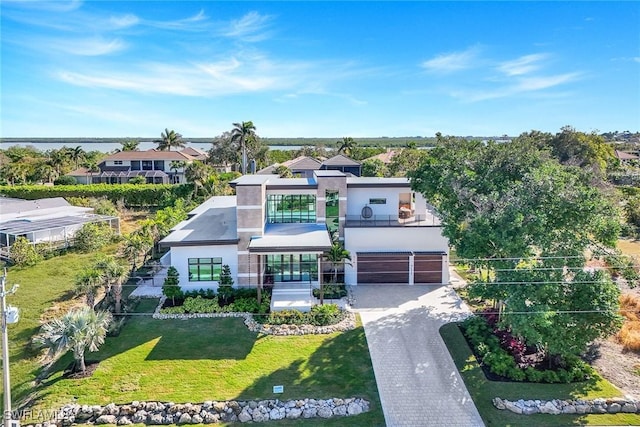 view of front of property with a front yard and a garage