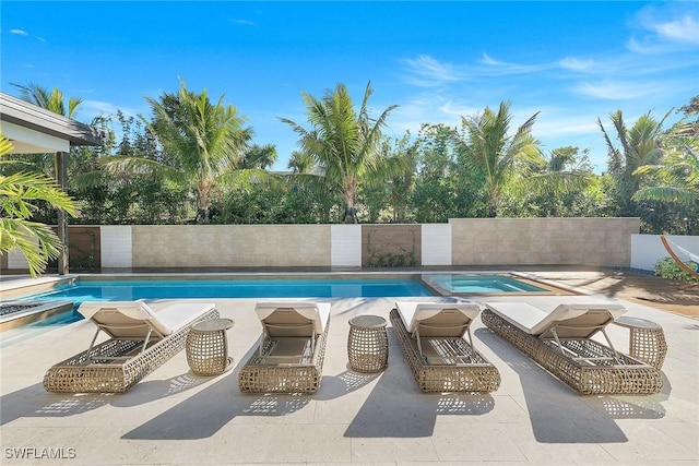 view of swimming pool featuring an in ground hot tub