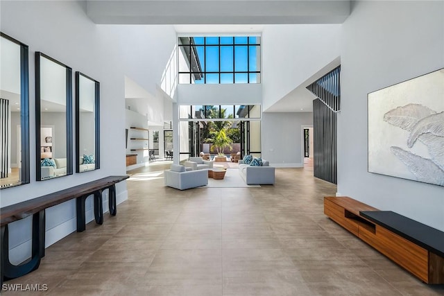 interior space with concrete flooring and a high ceiling