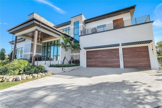 modern home with a garage and a balcony