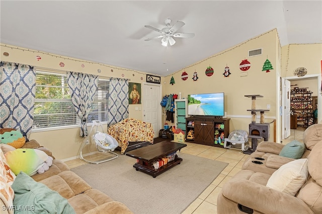 living room with ceiling fan, light tile patterned floors, and lofted ceiling