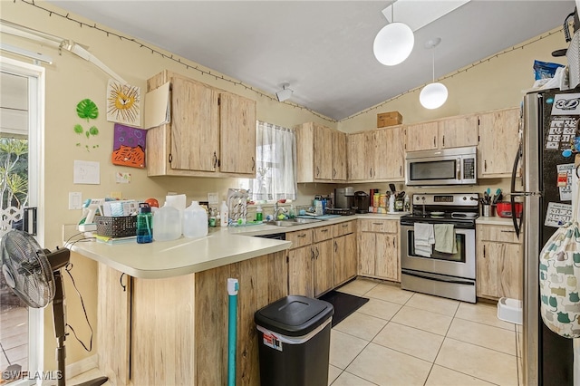 kitchen with light brown cabinets, kitchen peninsula, stainless steel appliances, and vaulted ceiling