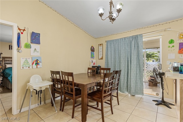 tiled dining area with vaulted ceiling and a chandelier